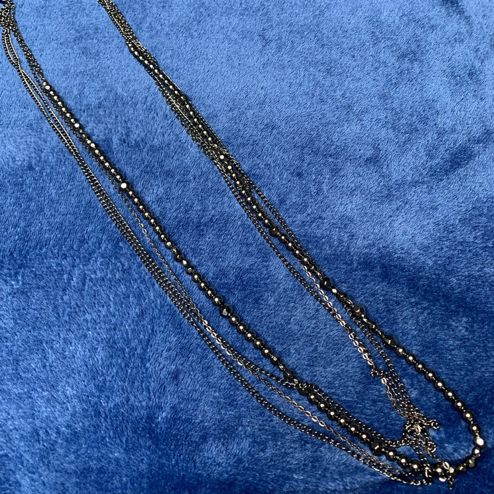 Long black multilayered necklace.